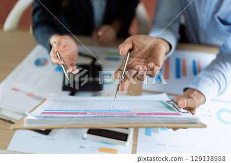 Data Analysis. Professionals reviewing financial reports and discussing strategies. 129138988