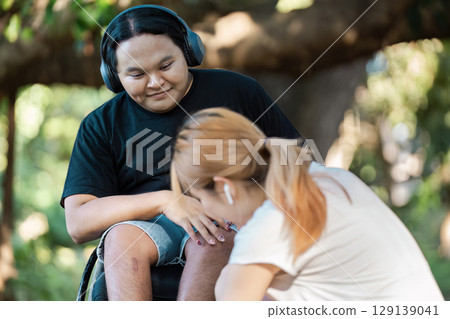 Inclusive Outdoor Activity with Disabled Person Enjoying Nature and Friendship 129139041