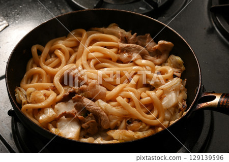 Fried udon noodles being cooked Fried udon noodles being cooked 129139596
