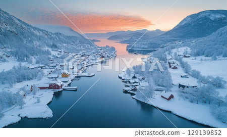 A snowy landscape with a river and houses 129139852