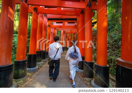 Japanese young couple walk along  big torii gate, Fushimi Inari, Kyoto 129140213