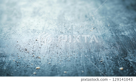 Abstract background textured metallic surface with scattered particles and brushed finish creates unique and modern backdrop. This abstract design evokes sense of depth and intrigue 129141043