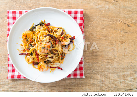 spicy spaghetti seafood on plate 129141462
