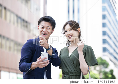 A couple searching for a route on a smartphone A couple searching for a route on a smartphone 129141468