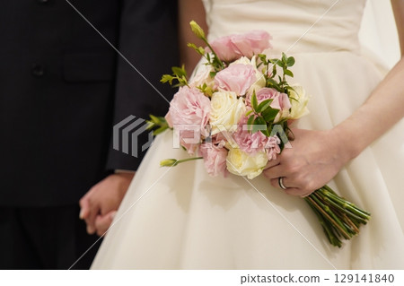 wedding bouquet in hands of the bride wedding bouquet in hands of the bride 129141840