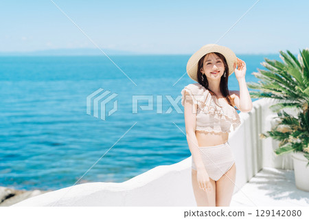A woman in a swimsuit enjoying vacation at a resort 129142080