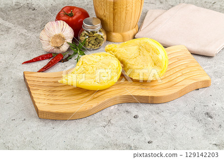 Italian traditional yellow Scamorza cheese 129142203