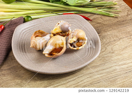 Snails baked with garlic and spices Snails baked with garlic and spices 129142219