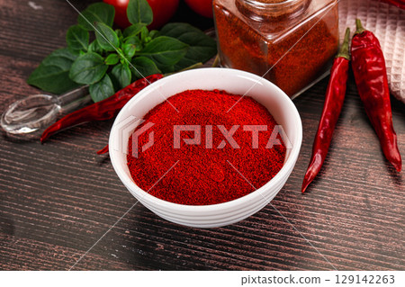 Spicy dry paprika powder in the bowl Spicy dry paprika powder in the bowl 129142263