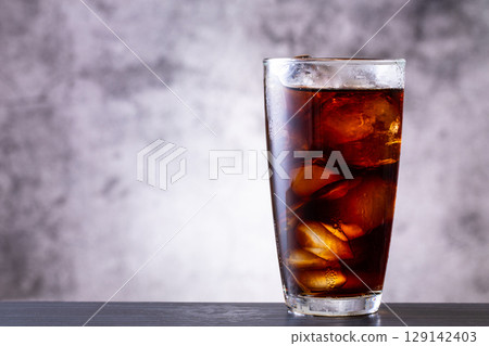 Drinking iced coffee at a cafe 129142403