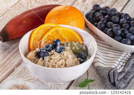 Oats porridge with blueberry, kiwi and orange 129142428