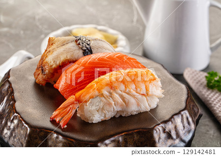 Japanese cuisine - sushi with eel, salmon and prawn 129142481