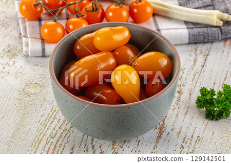 Marinated yellow cherry tomatoes heap 129142501