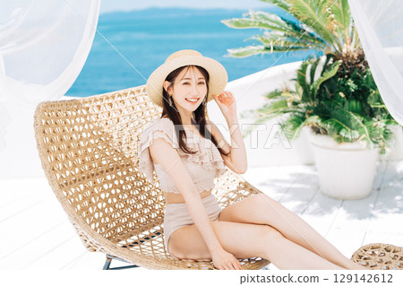 Young woman enjoying a beach resort Young woman enjoying a beach resort 129142612