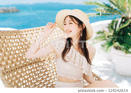 Young woman enjoying a beach resort Young woman enjoying a beach resort 129142614