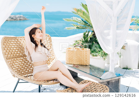 Young woman enjoying a beach resort Young woman enjoying a beach resort 129142616