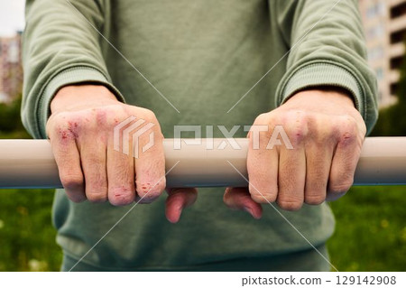 A Firm Grip on a Fitness Bar in a Vibrant Urban Scene, Engaging in Active Training A Firm Grip on a Fitness Bar in a Vibrant Urban Scene, Engaging in Active Training 129142908