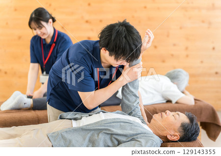 Male physiotherapist providing physiotherapy to a senior man Male physiotherapist providing physiotherapy to a senior man 129143355