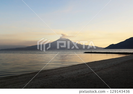 The sunset-colored sea and Sakurajima 129143436