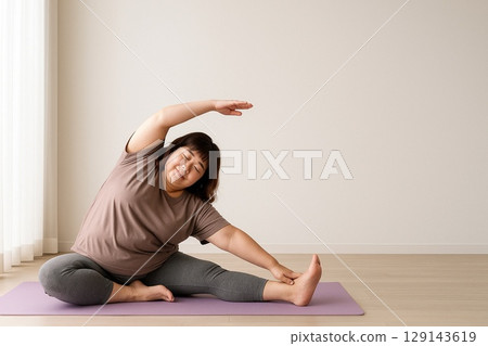 Japanese Middle-aged Woman Stretching in Yoga 129143619