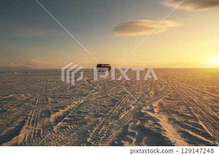The russian vans on frozen lake baikal, siberia, Russia. The deepest lake in the world with beautiful cracked ice and snow on surface. 129147248