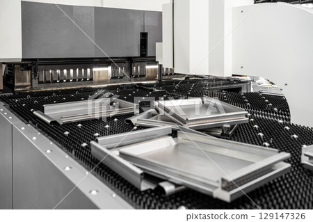 Automatic metal sheet bending machine at work in factory. CNC Panel Bender (Press Arm Type) 129147326