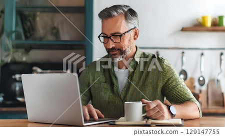 positive delighted man working on his laptop positive delighted man working on his laptop 129147755