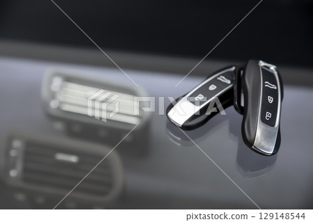 Car keyring and remote control key in vehicle interior. 129148544