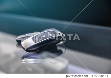 Car keyring and remote control key in vehicle interior. 129148551