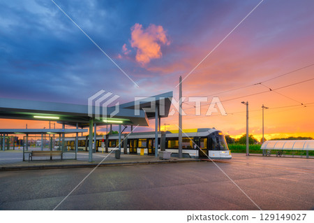 Tram stop. Public transport and sky during sunset. Architectural and infrastructural view. 129149027