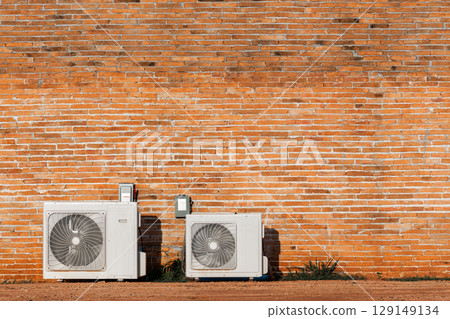 Air cooled condensers isolated on red brick wall. 129149134