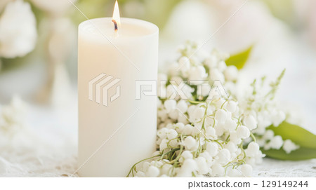 White ceremonial candle surrounded by delicate lilies of the valley flowers, symbol of christening White ceremonial candle surrounded by delicate lilies of the valley flowers, symbol of christening 129149244
