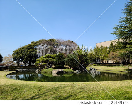 A park with beautiful greenery and a pond A park with beautiful greenery and a pond 129149554