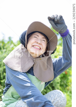 Japanese woman gardening and worried about sunburn Japanese woman gardening and worried about sunburn 129150971