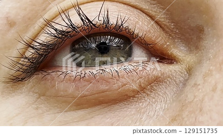 Focus on right green eye of attractive girl blinking and looking into camera. Portrait of upset female face. Sorrowful facial expression of young woman. Unhappy sight of beautiful lady. Close up Focus on right green eye of attractive girl blinking and looking into camera. Portrait of upset female face. Sorrowful facial expression of young woman. Unhappy sight of beautiful lady. Close up 129151735