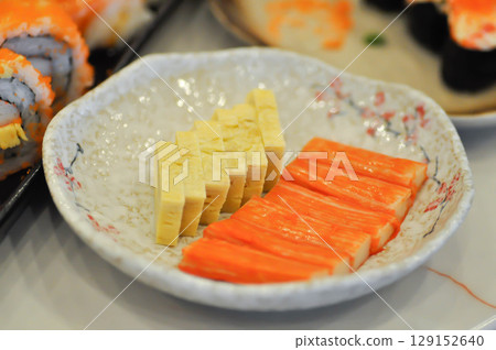 Japanese omelete, japanese omelette or sweet egg or sweetened egg or tamagoyaki or Japanese rolled omelette and imitation crab or crab stick Japanese omelete, japanese omelette or sweet egg or sweetened egg or tamagoyaki or Japanese rolled omelette and imitation crab or crab stick 129152640