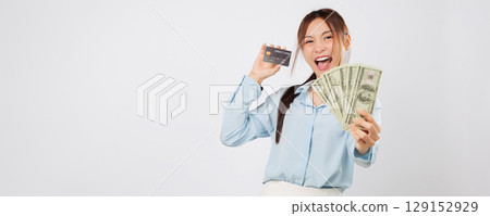 Woman proudly holding credit card and money fan, excited and happy about payment money success, showing clear control over her personal finance and spending options. isolated studio white background 129152929