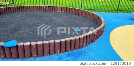 A vibrant and colorful playground featuring a spacious sandpit along with durable rubber flooring 129153010