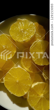 A Bowl Filled with Freshly Sliced Lemons, Their Aromatic Aroma Inviting You to Enjoy A Bowl Filled with Freshly Sliced Lemons, Their Aromatic Aroma Inviting You to Enjoy 129153093