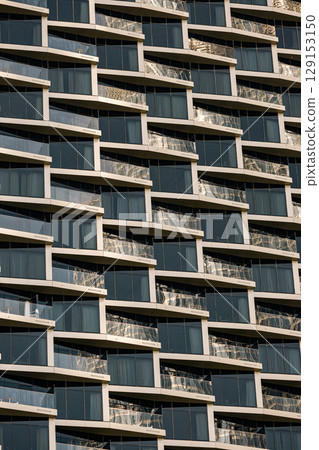 apartment building, similar glass balconies. Geometric architecture background. apartment building, similar glass balconies. Geometric architecture background. 129153150