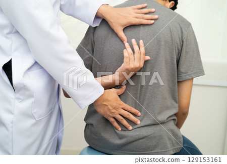Physical therapy, Asian therapist doctor treat perform pain young man in hospital. 129153161