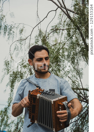 Happy Man Playing Traditional Organetto With Joy  129153164