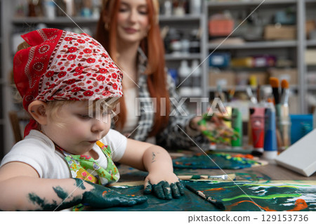 Engaging in a Creative Art Session Where a Mother and Her Child Bond and Create Together 129153736