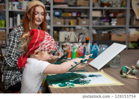 Creative Moments Engaging in Painting Together with Your Child and an Adult Figure 129153754