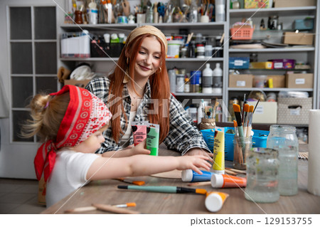 Creative Moments A Mother and Her Child Crafting Together in Joyful Harmony and Fun 129153755
