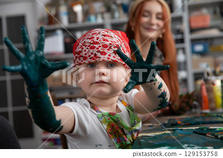 Creative Kid Engaged with Paint An Exciting and Fun Art Activity for Young Artists Creative Kid Engaged with Paint An Exciting and Fun Art Activity for Young Artists 129153758