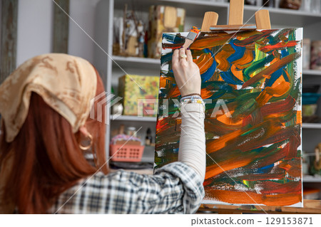 A Creative Artist Passionately Painting An Abstract Canvas Inside A Bright Studio Environment A Creative Artist Passionately Painting An Abstract Canvas Inside A Bright Studio Environment 129153871