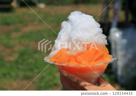 Fruit shaved ice with a mandarin orange Fruit shaved ice with a mandarin orange 129154435