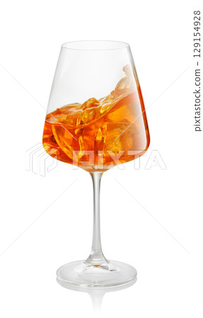 glass of aperol spritz cocktail splashing inside isolated on white background glass of aperol spritz cocktail splashing inside isolated on white background 129154928