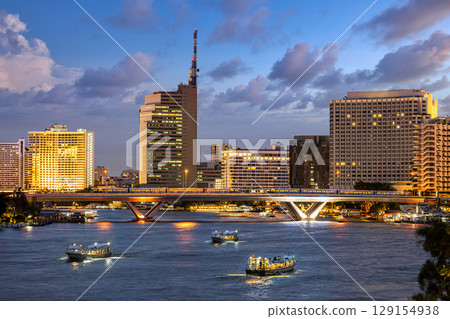 Aerial view of Taksin Bridge with Chao Phraya River, Bangkok Downtown Thailand at twilight time. Financial district and business centers in smart urban city. 129154938